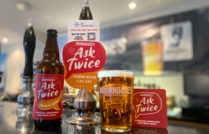The Ask Twice beer bar pump clip, bottle and drip mat will feature a QR code that leads to a dedicated online Six Connections support page.